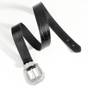 Detail of black faux-crocodile belt featuring a silver butterfly buckle with rhinestones