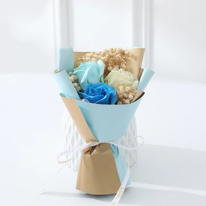 Mini artificial rose and baby's breath bouquet wrapped in blue with LOVE IS ribbon
