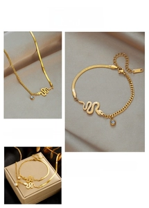 Detail of gold snake jewelry set with blue rhinestone and stainless steel texture