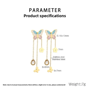 Detail view of gold stainless steel butterfly tassel earrings with enamel and crystals