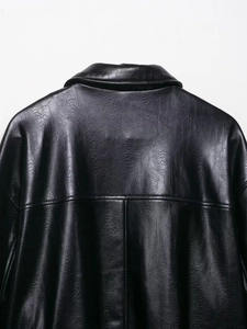 Close-up of the black faux leather aviator jacket showing stitching and texture details
