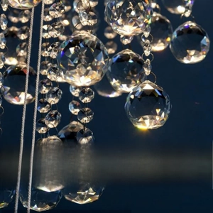 Transparent crystal prism ball for chandelier with multifaceted cut and metal hanging ring