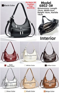 Detailed view of crescent shoulder bag featuring premium dual metal zippers and PU texture