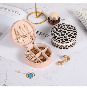 Detail view of pink leather and leopard print jewelry box with organized compartments