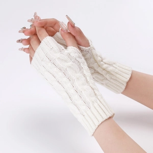 Close-up of cable knit texture on off-white fingerless arm warmers for winter warmth