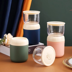 Close-up of portable dual-layer breakfast cup with leak-proof lid and spoon in stylish colors