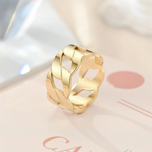 Close-up of a gold-toned titanium steel hollow chain ring with smooth polished finish.