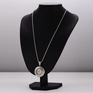 Silver stainless steel necklace with round embossed lion head pendant on black mannequin