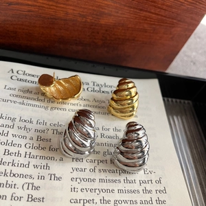 Twisted geometric square stud earrings in gold and silver finish on vintage book