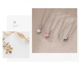 Detailed view of heart zircon pendant necklaces in white, pink, red and emerald green