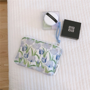 Detail of blue tulip floral canvas pouch with simple wish label and braided wrist strap