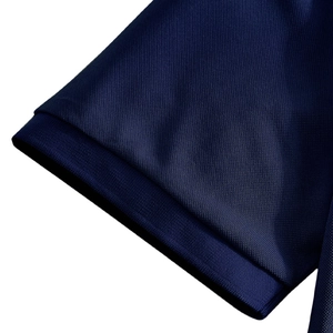 Detailed macro view of the navy blue polo shirt ribbed cuff and breathable piqué mesh fabric