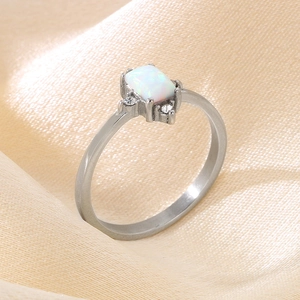 Minimalist silver steel ring with rectangular opal and diamonds on champagne satin