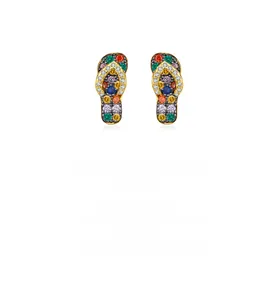 Macro detail of S925 silver flip-flop earrings with colorful crystals in gold finish