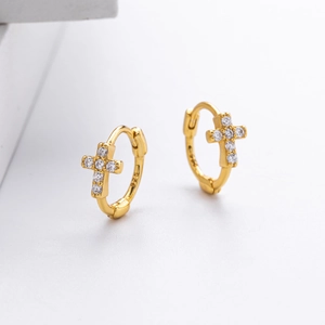 Macro view of gold S925 sterling silver hoop earrings with zircon cross charms