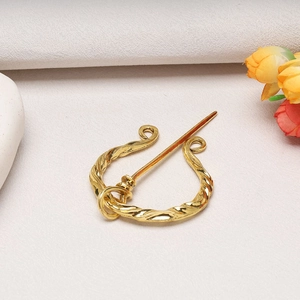 Vintage gold Viking brooch with twisted metal design for shawls and coats