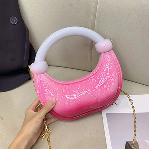 Detail of pink gradient acrylic crescent bag with round handle and gold chain strap