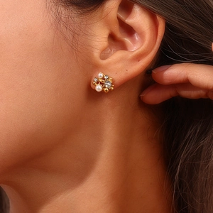 Close-up of elegant flower cluster earrings with pearls and crystals in 18K gold finish