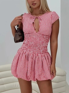 Detailed view of red and white plaid dress featuring elastic smocked waist and tie-up front