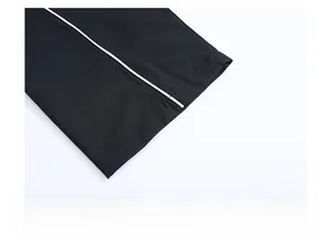 Detail of straight leg hem with vertical white stripe on black ice silk pants
