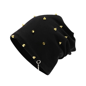 Thick black knitted beanie with gold cone studs and silver ring in punk rock style