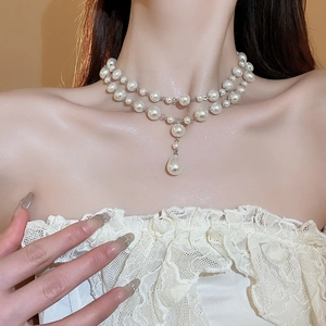French retro double-layer necklace featuring teardrop pearls on a female model
