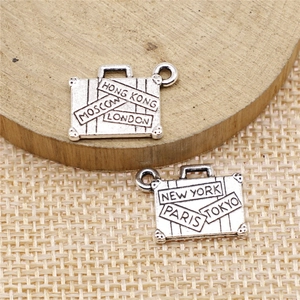Pair of silver suitcase charms for DIY jewelry featuring engraved global city names