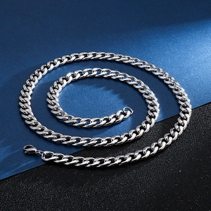 Macro detail of high-polished silver stainless steel Cuban chain necklace links