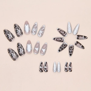 Macro view of long stiletto press on nails with metallic silver finish and marble texture