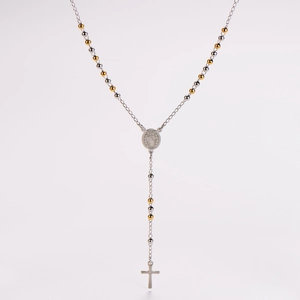 Detailed view of bicolor rosary necklace with gold-silver beads and a religious cross pendant
