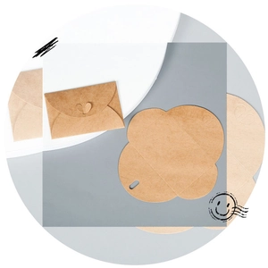 Detailed view of yellow kraft paper envelopes featuring creative clover-shaped closures