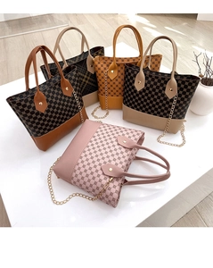 Detailed display of colorful patterned leather tote bags with metal chains and handles