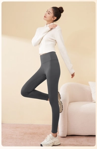 Detail of high-waist dark grey yoga leggings with tummy control and shaping effect