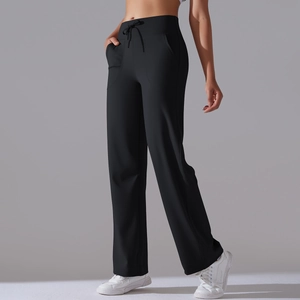 Detail view of high waist black yoga pants with drawstring waist and deep side pockets