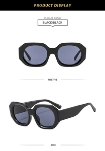 Close-up of thick black polygonal frame sunglasses with dark grey semi-transparent lenses