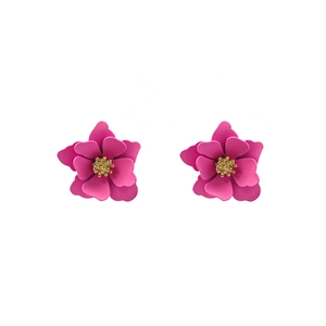 Detail of sweet pink multi-layer flower earrings with gold center on white backdrop