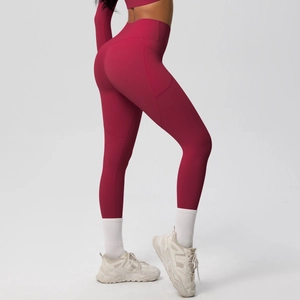 Detail view of high waisted maroon yoga leggings with practical side pockets for fitness