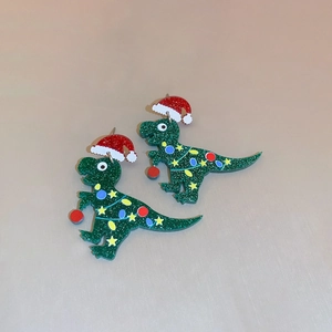 Sparkly green acrylic dinosaur earrings with red Christmas hats and star details