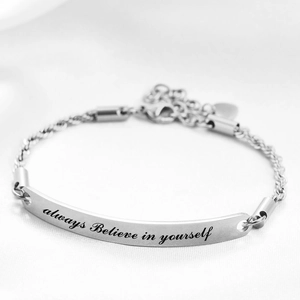 Detail of laser engraved Always Believe In Yourself quote on adjustable steel bracelet