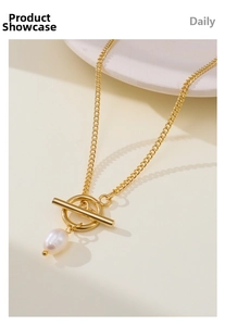 Close-up of gold titanium steel OT buckle necklace featuring a baroque pearl pendant