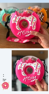 Detail of rose red donut water bottle featuring silicone sleeve and adjustable strap
