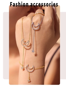 Detail of model wearing gold and silver star and moon charms with sparkling cubic zirconia