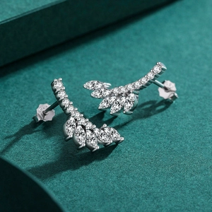 S925 sterling silver leaf stud earrings with marquise crystals on dark green surface