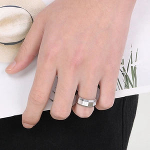 Detail of 8mm brushed faceted stainless steel ring on hand with a vacation aesthetic