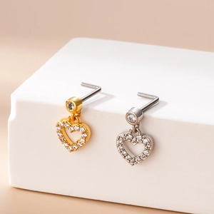 L-shaped heart dangle nose studs with micro-paved zircons in gold and silver finish