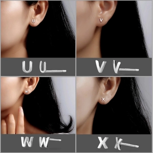 Macro detail of S999 sterling silver alphabet stud earrings in U, V, W, X styles