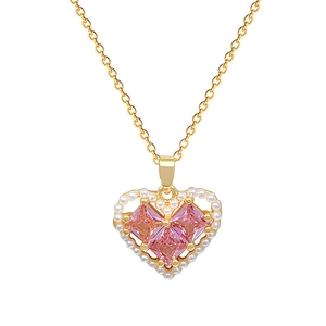 Golden heart necklace with a pink gem and pearls shown on a clean white background