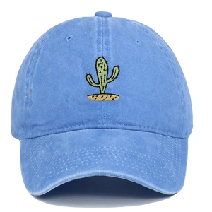 Close-up of green cactus embroidery on vintage washed blue cotton baseball cap
