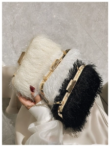 Detail of fringe evening bags in white and black with gold metal frames and chain straps