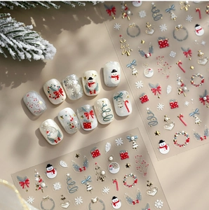 Detailed Christmas nail stickers with gold embossed snowmen, trees and festive wreaths